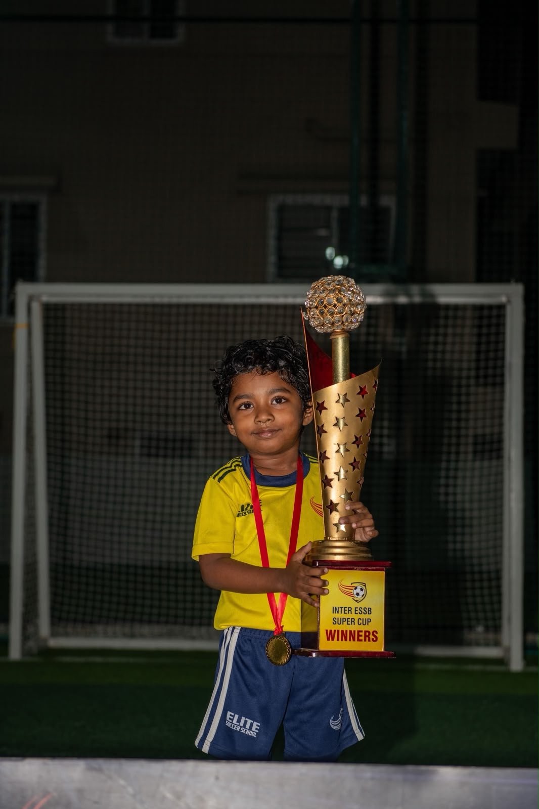 Young ESSB player with a tournament trophy