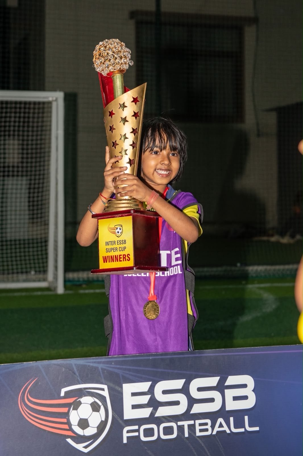 Young ESSB player with a tournament trophy