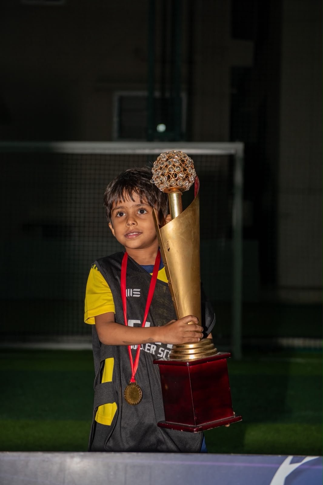 Young ESSB player with a tournament trophy